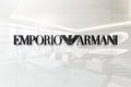 Emporio armani on glossy office wall realistic texture